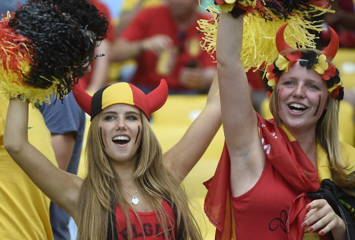 Axelle Despiegelaere, a Belgium supporter cheers with her friend as they wait for the start of the Group H football match between Belgium and Russia at the Maracana Stadium in Rio de Janeiro during the 2014 FIFA World Cup on June 22, 2014. AFP PHOTO / MARTIN BUREAU (Photo credit should read MARTIN BUREAU/AFP/Getty Images)