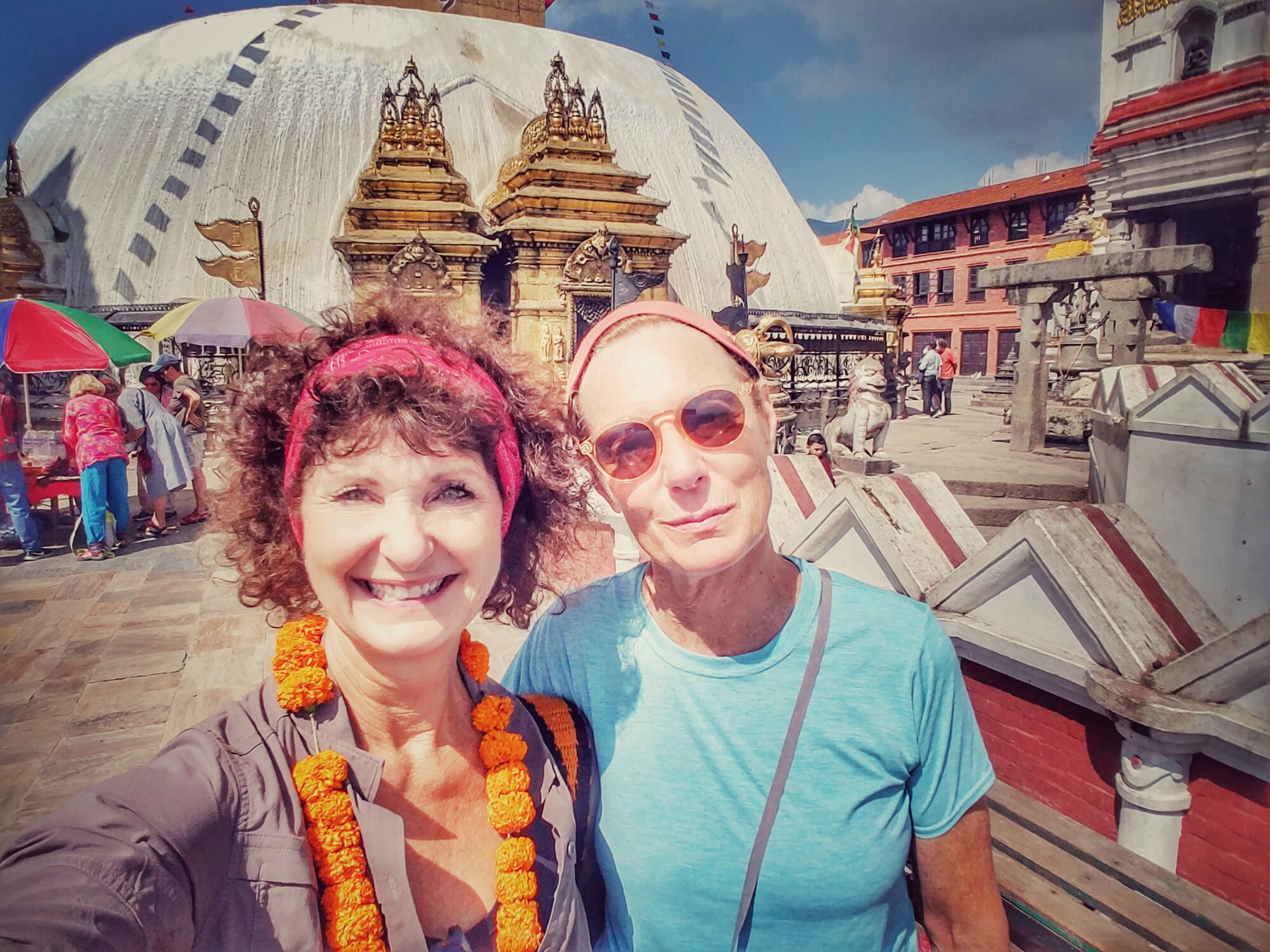 Two women smile at a camera during a visit to Kathmandu, Nepal.