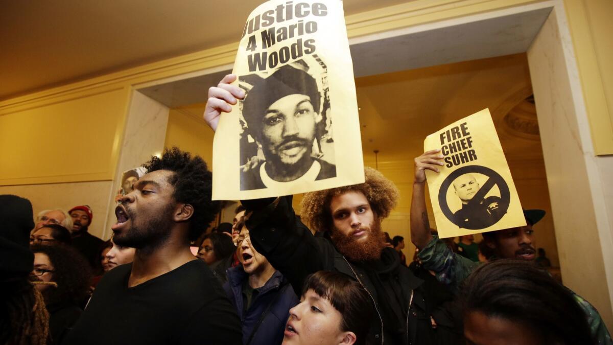 Demonstrators protest the shooting of Mario Woods outside a San Francisco Police Commission meeting in December 2015.