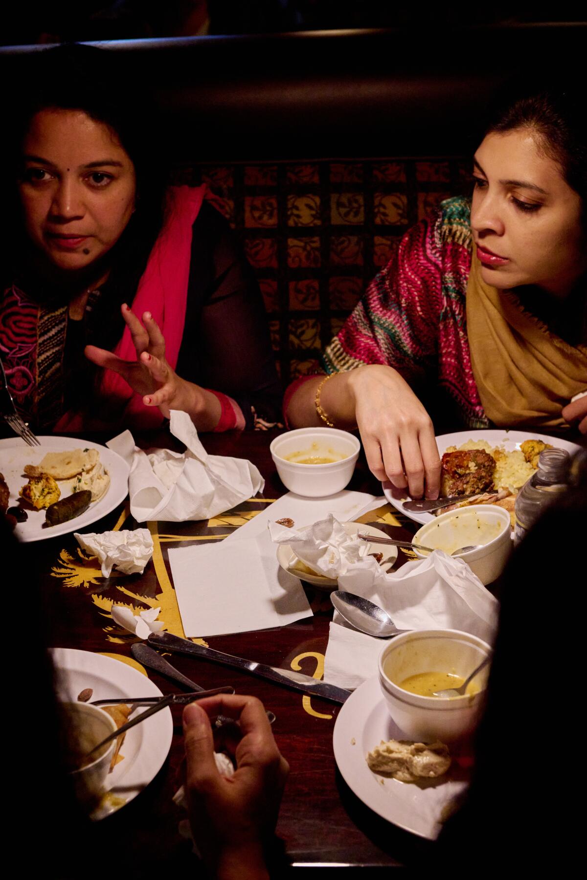 Radhika Nayir and Rexa Raheja break their fast with the Iftar buffet during Ramadan at Desert Moon Grill in Anaheim.