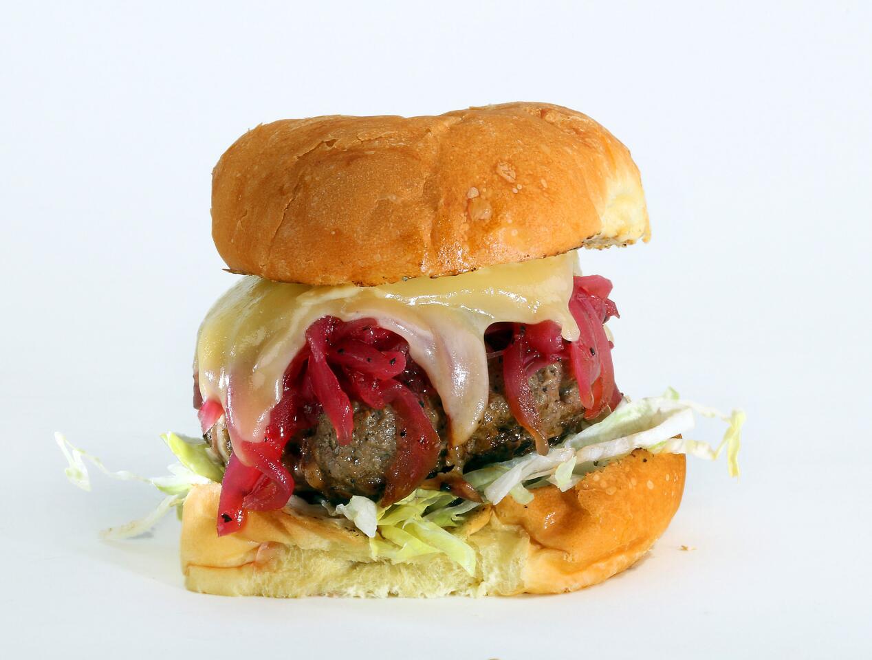 The Howie burger is topped with a gastrique of red onions and homemade Dijonnaise.