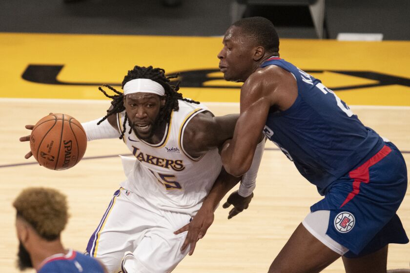 Los Angeles Lakers forward Montrezl Harrell, left, drives toward the basket as Los Angeles Clippers.