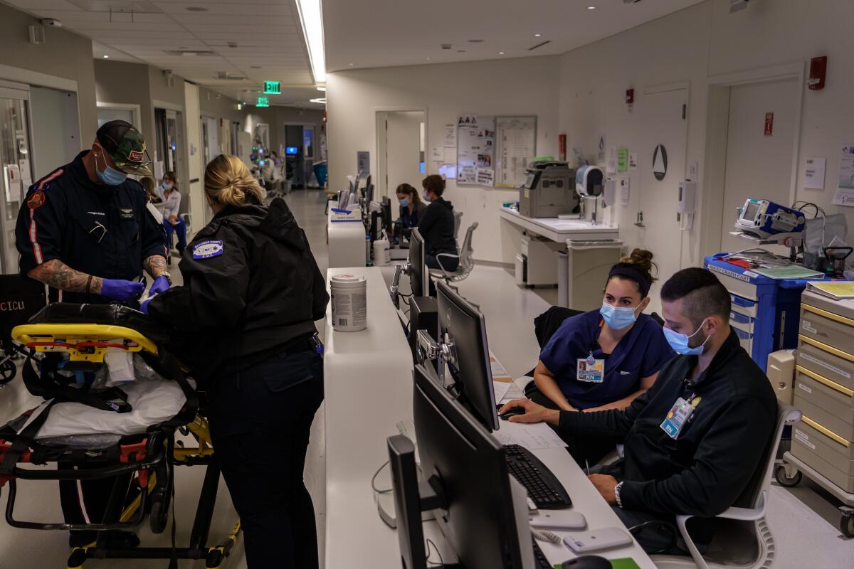 Registered nurse Erin Jenkins talks to a colleague during her work shift at a San Diego hospital April 18.