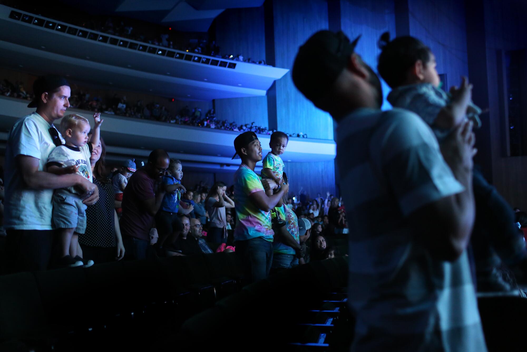 Tristan Dingson (center) stands with son Tyson Dingson, during "Baby Shark Live!" in Long Beach.