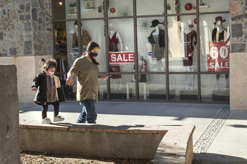 LYNWOOD, CA - NOVEMBER 30, 2020: Anabel Garcia, left, walks with her aunt Sucelly Morales while visiting Plaza Mexico shopping mall in Lynwood. They are from Gardena. New coronavirus restrictions limit malls to 20% of capacity. (Mel Melcon / Los Angeles Times)