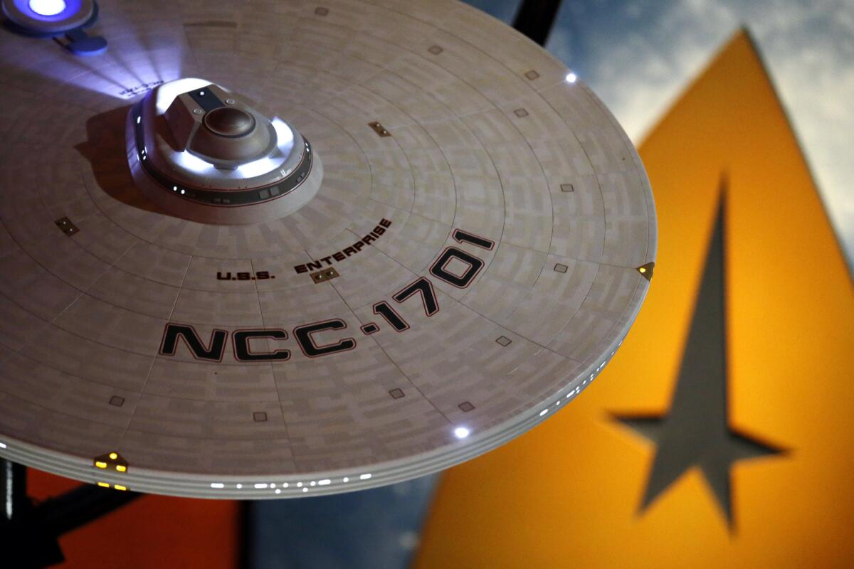 A model of the USS Enterprise hangs above an exhibit for a 50th anniversary celebration of the "Star Trek" franchise at Seattle's Experience Music Project Museum.