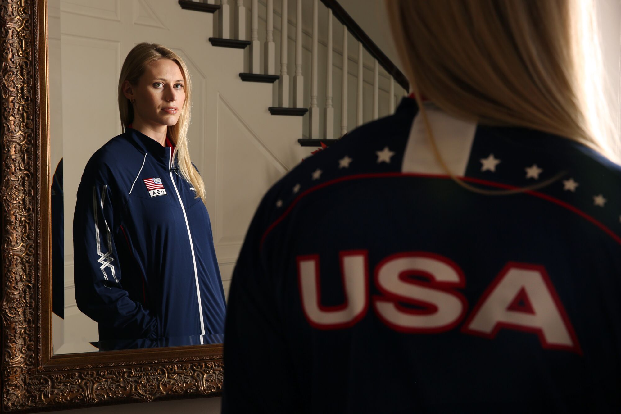Hayley Hodson stands in her parents' Newport Beach home while wearing her U.S. Women's National Team jacket.
