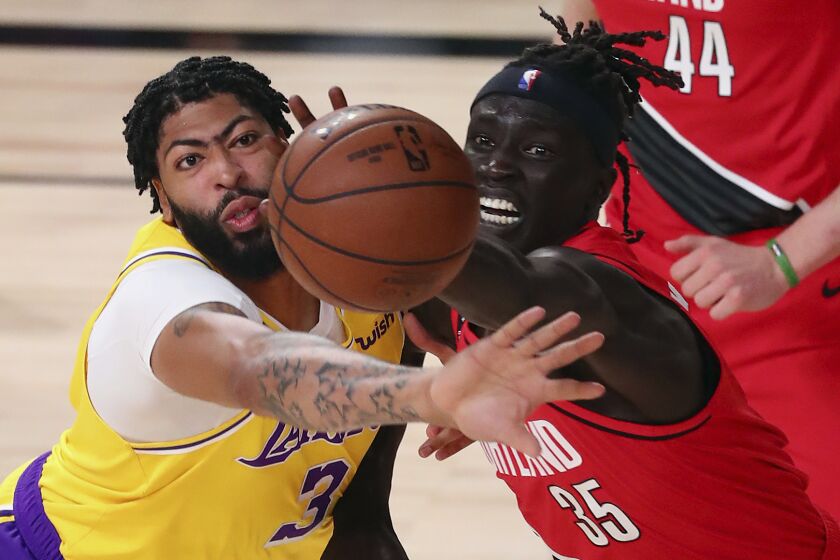 Lakers forward Anthony Davis, left, and Portland Trail Blazers forward Wenyen Gabriel battle for the ball during Game 2.