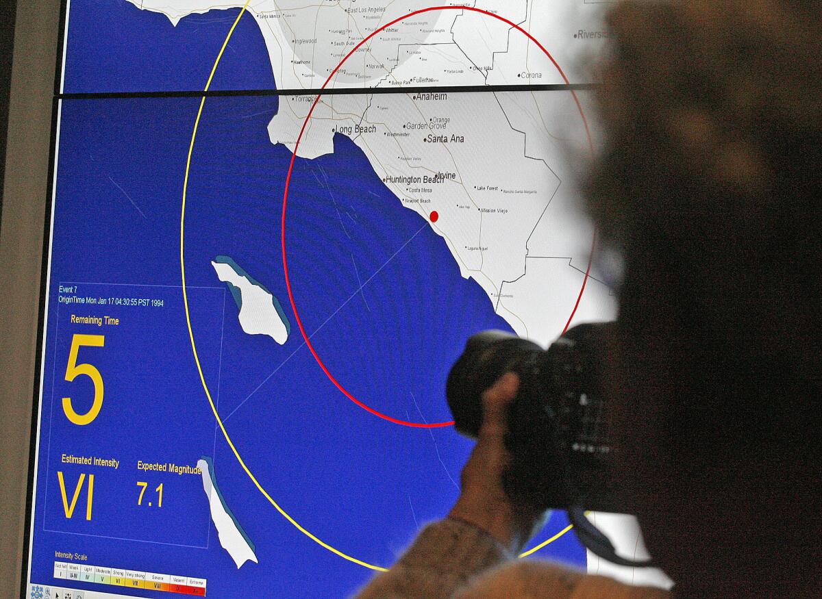 Members of the media are given a demonstration of an early earthquake warning system, which displays the estimated intensity of an earthquake in this file photo from Monday, Jan. 28, 2013.