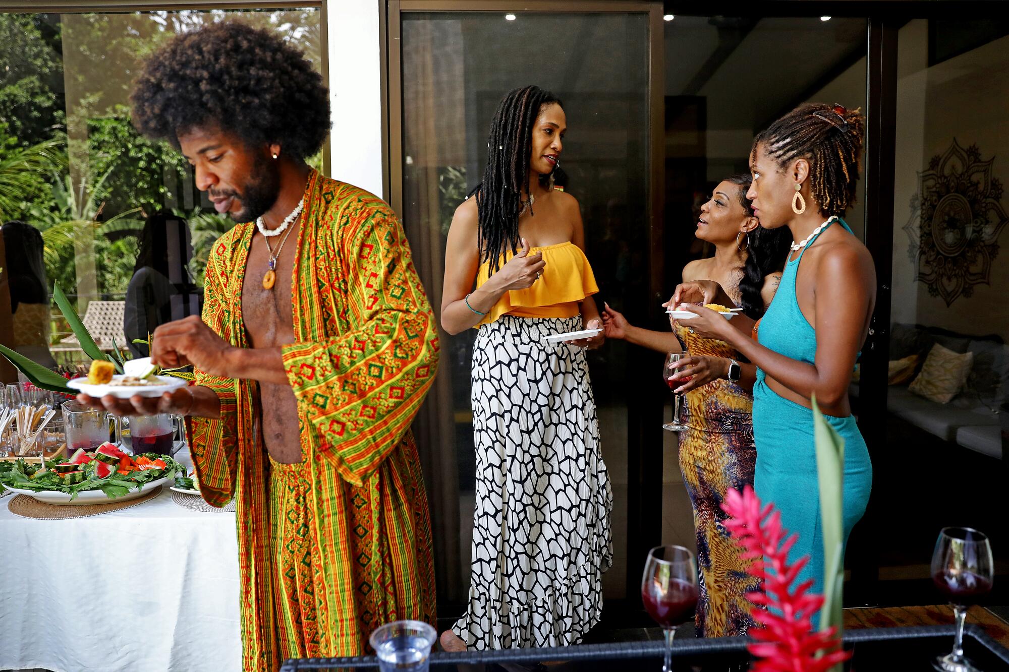 Black people gather on a patio.