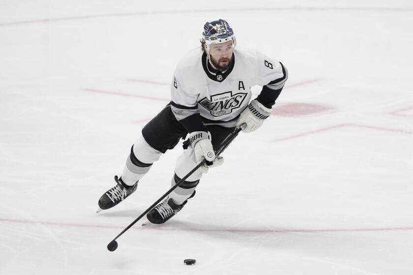 FILE - Los Angeles Kings defenseman Drew Doughty (8) skates with the puck during the first period an NHL hockey game against the Dallas Stars in Dallas, March 16, 2024. (AP Photo/LM Otero, File)