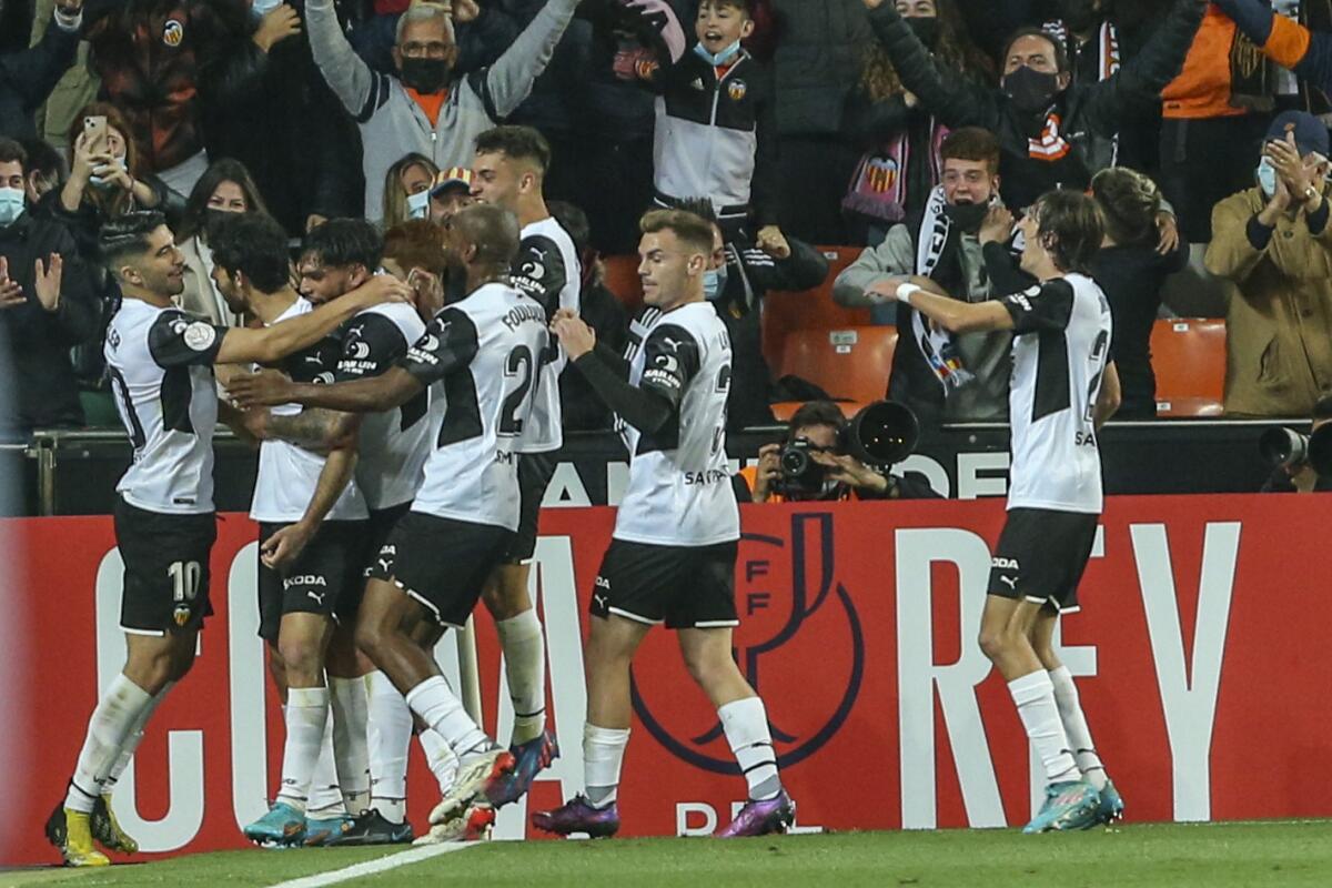 Valencia's Goncalo Guedes, second left, celebrates after scoring the opening goal with his teammates during a Spanish Copa del Rey semifinal second leg soccer match between Valencia and Athletic Bilbao at the Mestalla stadium in Valencia, Spain, Wednesday, March 2, 2022. (AP Photo/Alberto Saiz)