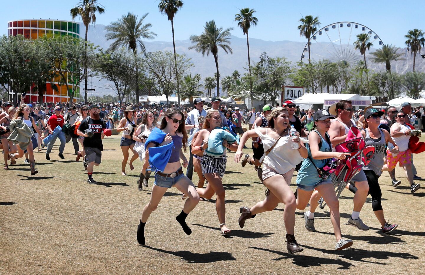 Fans race to grab the best viewing spots after gates opened at the Stagecoach festival Friday.