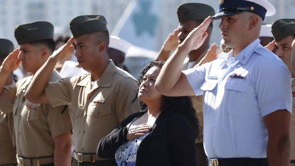 Virginia Lopez Coleman, whose husband is a veteran and daughter is active military, joins service members in becoming a United States citizen during a ceremony aboard the carrier Midway museum.