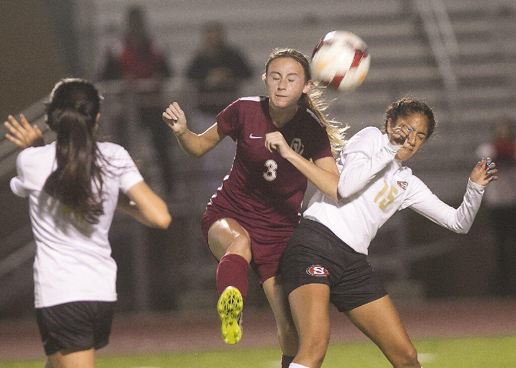 Ocean View's Taylor Voegelie (3) kicks the ball into scoring position as she fends off Segerstrom defenders.