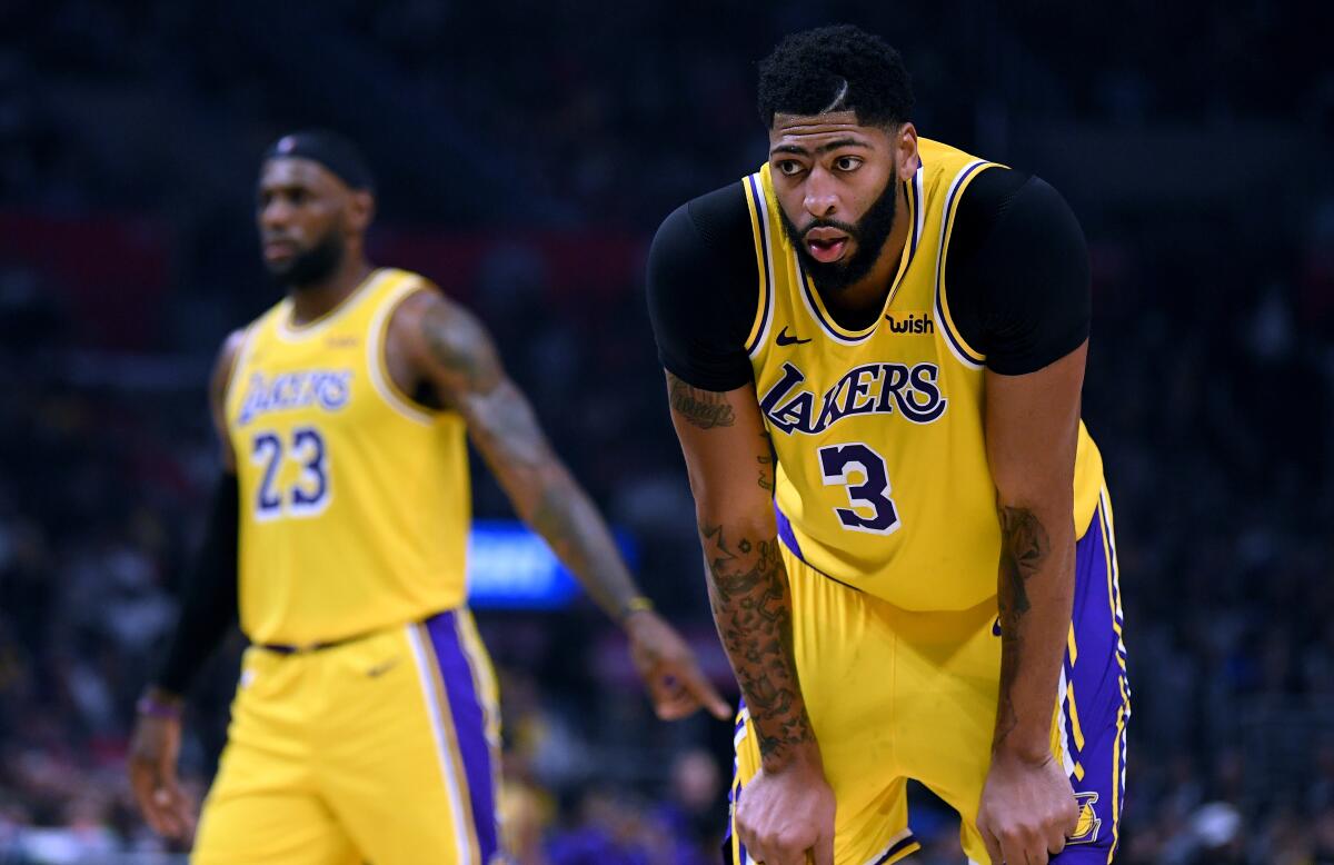 Lakers star Anthony Davis stands on the court during a game against the Clippers.