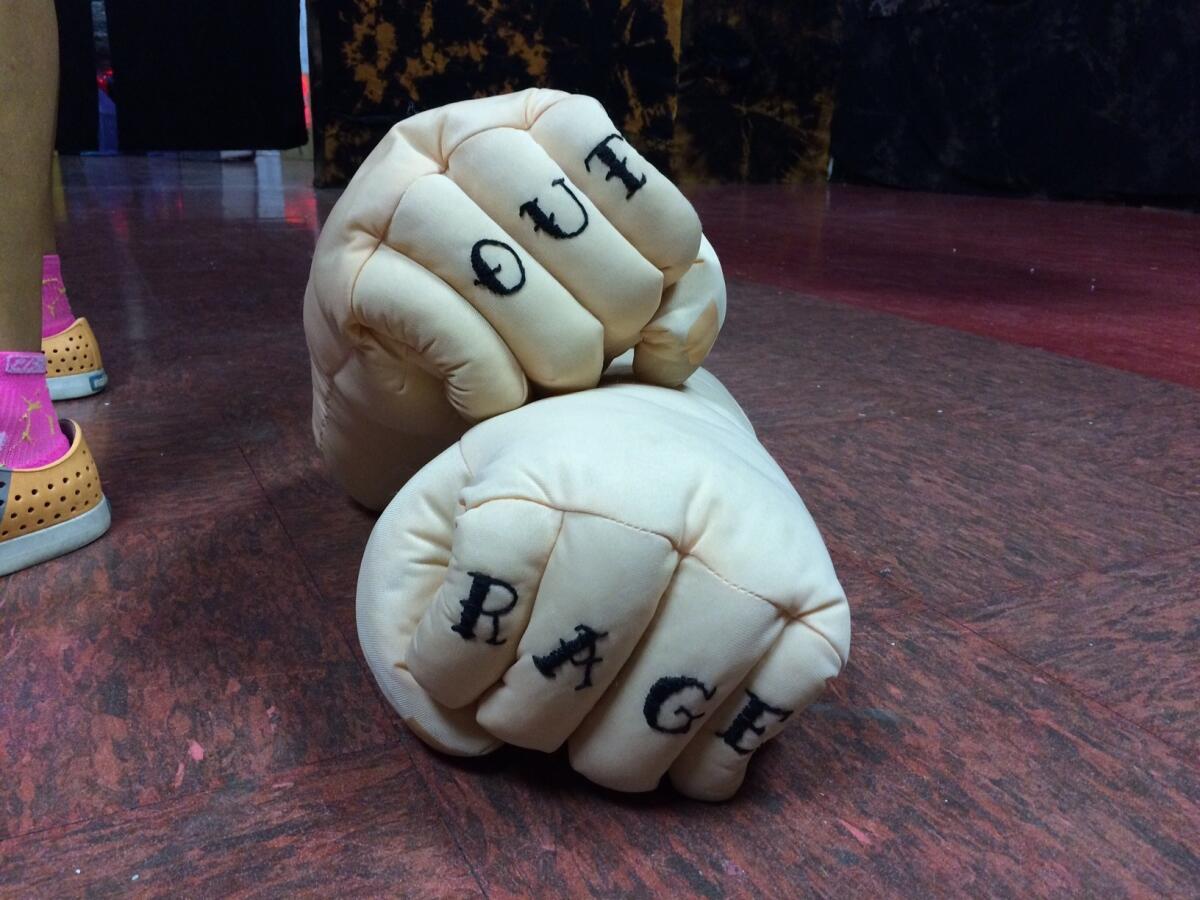 A pair of specially crafted boxing gloves labeled "Out" and "Rage" rest on the floor of one of the haunted house's rooms. The installation addresses questions of inequity and homophobia while also joyfully lampooning gender studies jargon.
