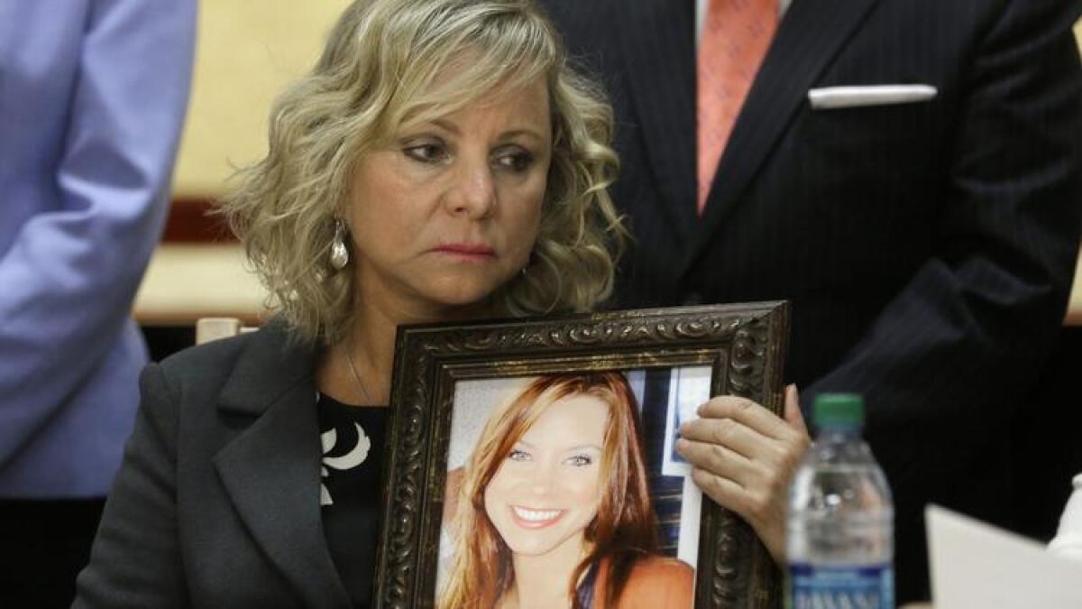 Debbie Ziegler holds a photo of her daughter, Brittany Maynard, the California woman with brain cancer who moved to Oregon to legally end her life last fall, during a news conference to announce the reintroduction of aid-in-dying legislation in August.