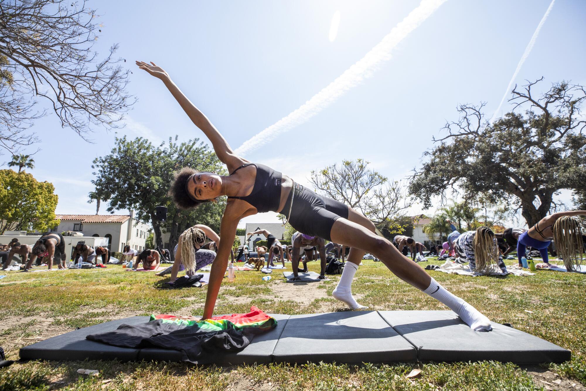 Ivy Coco helps lead a yoga gathering on April 4 at L.A. High Memorial Park.