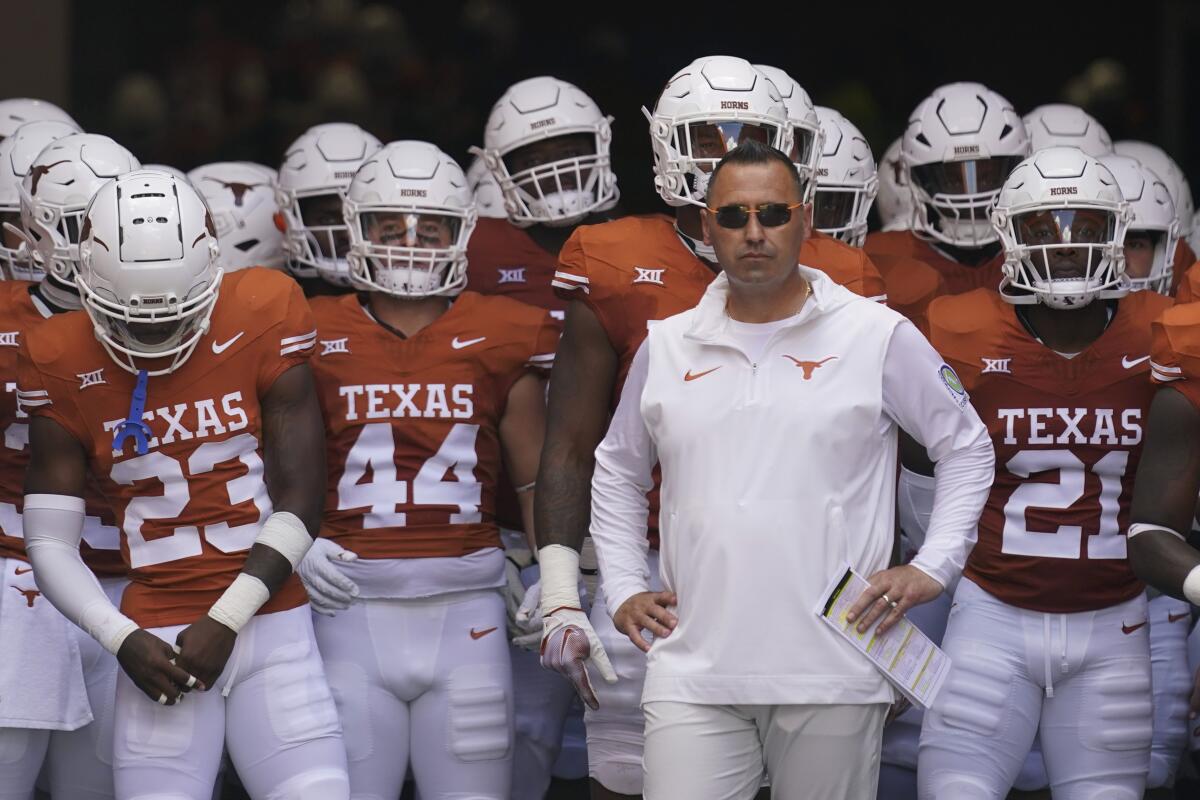 Texas coach Steve Sarkisian, center, waits to take the field with his team before a game against Kansas on Sept. 30.