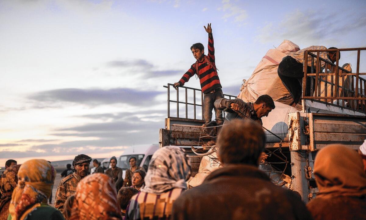Syrian Kurds load their belongings in the southeastern Turkish town of Suruc after fleeing an onslaught by Islamic State militants in northern Syria.