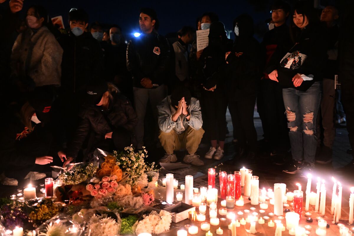 A man prays during a candlelight vigil for victims who suffer under China’s stringent lockdowns.