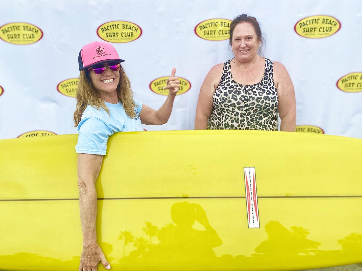 Amy Lepine won one of the two surfboards donated for the raffle by Debbie Gordon of Gordon Surfboards .