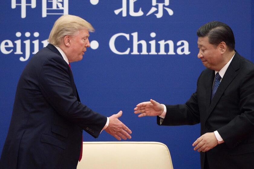 (FILES) In this file photo taken on November 9, 2017 China's President Xi Jinping shakes hands with US President Donald Trump (L) during a business leaders event at the Great Hall of the People in Beijing. - US President Donald Trump said June 18, 2019 he had a positive phone conversation with his Chinese counterpart Xi Jinping and that they will hold an "extended meeting" next week at the G20 summit. Trump's tweet set a more upbeat tone for his talks with Xi at the summit in Japan after growing questions over whether the world's two leading economies will be able to resolve their differences and end a huge trade war."Had a very good telephone conversation with President Xi of China. We will be having an extended meeting next week at the G-20 in Japan. Our respective teams will begin talks prior to our meeting," Trump said. (Photo by Nicolas ASFOURI / AFP)NICOLAS ASFOURI/AFP/Getty Images ** OUTS - ELSENT, FPG, CM - OUTS * NM, PH, VA if sourced by CT, LA or MoD **