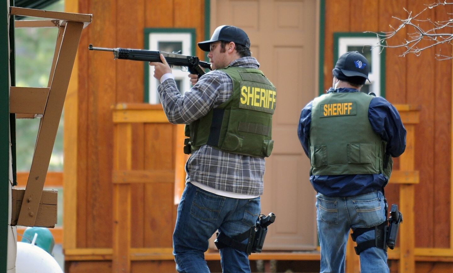 Sheriff's officers check houses for shooting suspect Christopher Dorner in Big Bear Lake.