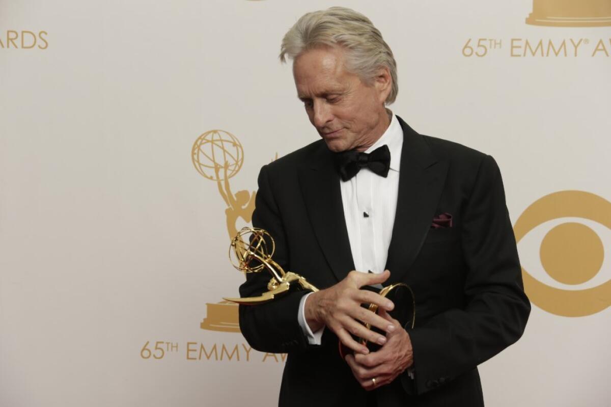 Michael Douglas cradles his Emmy for HBO's "Behind the Candelabra" at last year's Emmy Awards.