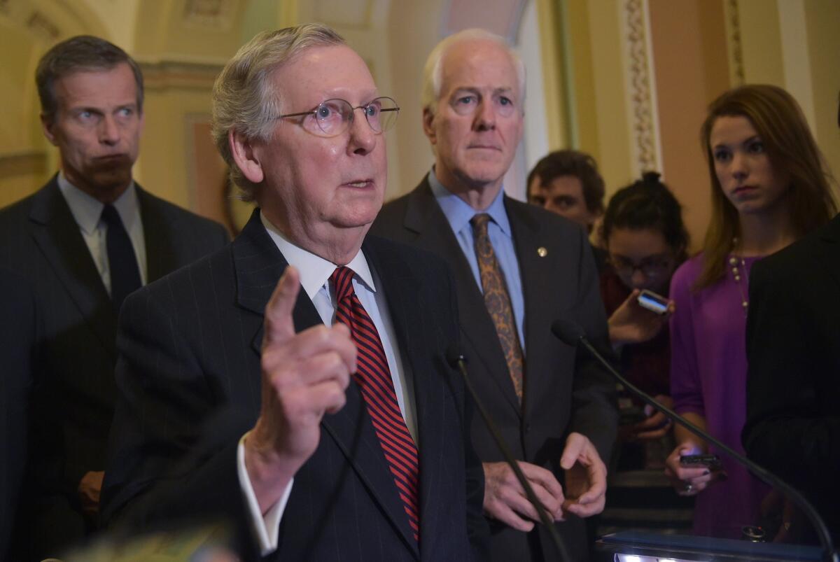 Senate Majority Leader Mitch McConnell (R-Ky.) speaks to reporters following the weekly Republican policy luncheon on Tuesday at the US Capitol in Washington, DC. Flanking McConnell are Sens. John Thune (R-SD) and John Cornyn (R-Texas).