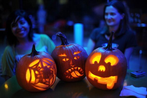 Contestants sit with their carved pumkin