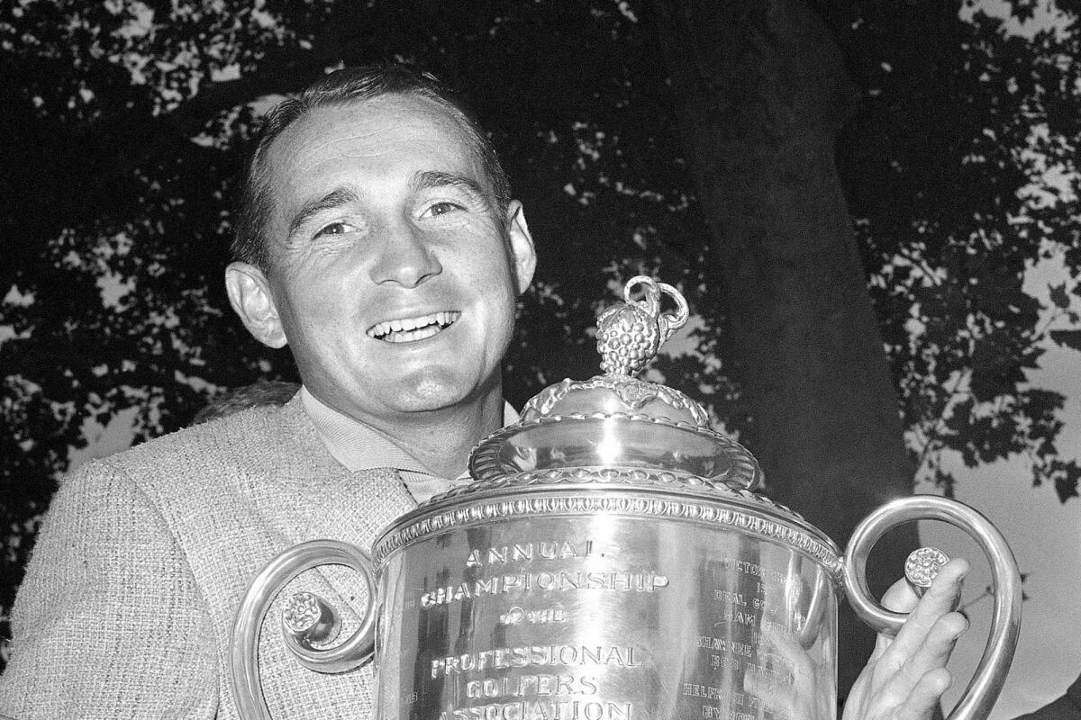 FIEL - Dow Finsterwald of Tequesta, Fla. poses with the trophy after winning the Professional Golfers Association 40th annual tournament at Llanerch Country Club in Havertown, Pa. on July 21, 1958. Finsterwald, a 12-time winner on the PGA Tour, died Friday night, Nov. 4, 2022, at his home in Colorado Springs, Colo. He was 93. His son, Dow Finsterwald Jr., said he died peacefully in his sleep. (AP Photo/File)