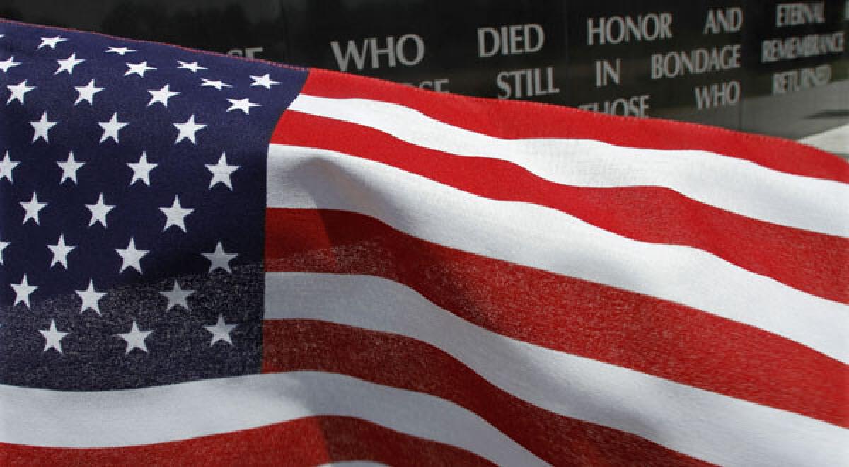 A United States flag blows in the wind near the Illinois Vietnam Memorial.