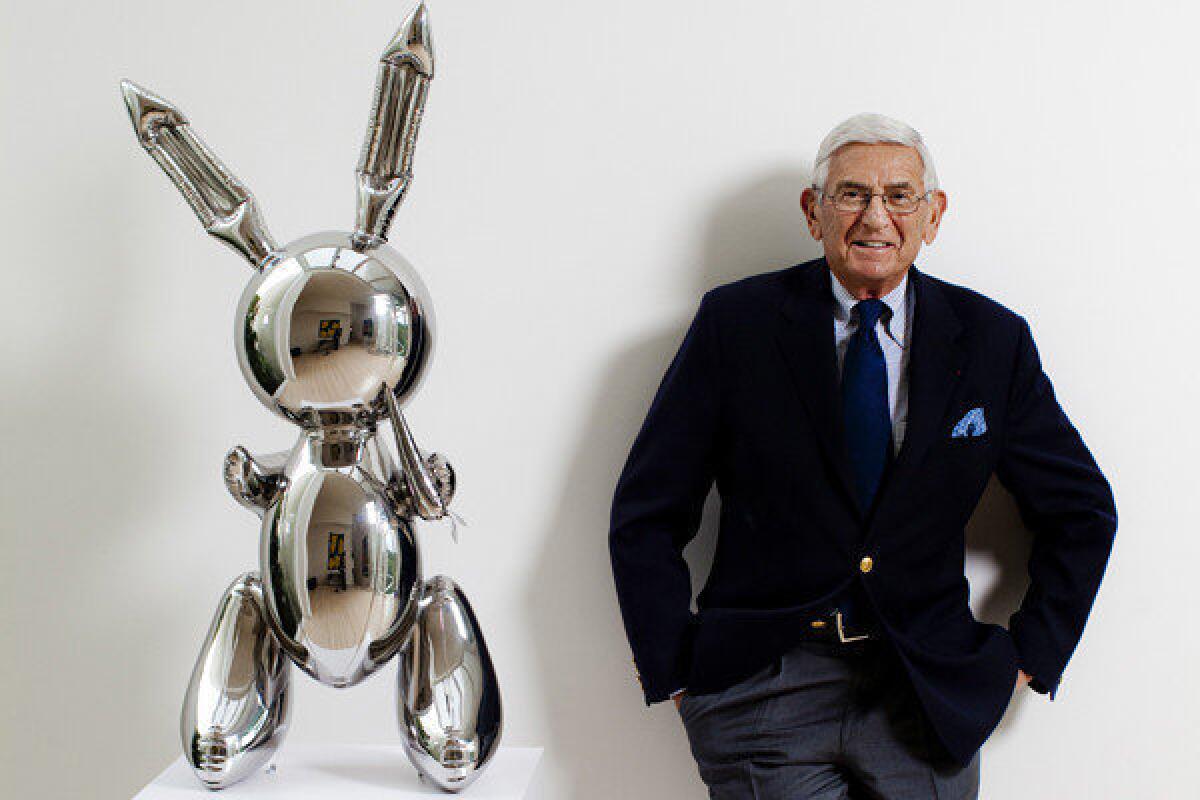 Eli Broad is pictured in his home with a stainless steel work by Jeff Koons called "Rabbit."