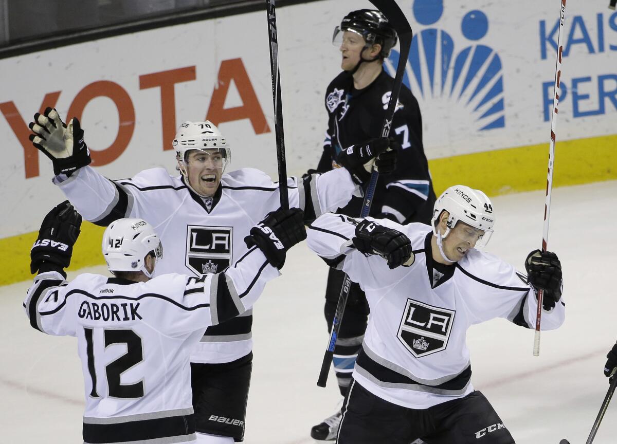 The Kings' Vincent Lecavalier, right, celebrates his goal with teammates Tanner Pearson and Marian Gaborik (12) as San Jose's Paul Martin skates past during the third period on Sunday night.
