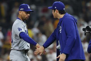 SAN DIEGO, CALIFORNIA - OCTOBER 09: Mookie Betts #50 of the Los Angeles Dodgers slaps hands with Shohei Ohtani #17 after defeating the San Diego Padres 8-0 in game four of the National League Division Series at Petco Park on Wednesday, Oct. 9, 2024 in San Diego. (Robert Gauthier / Los Angeles Times)