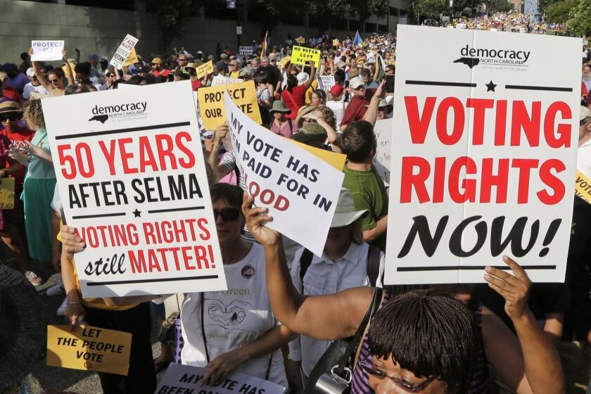 Demonstrators march through the streets of Winston-Salem, N.C., Monday, July 13, 2015, after the beginning of a federal voting rights trial challenging a 2013 state law. Election law experts say the case could determine how far Southern states can change voting rules after the nation's highest court struck down a portion of the federal Voting Rights Act just weeks before the North Carolina law was passed. (AP Photo/Chuck Burton) ORG XMIT: NCCB117
