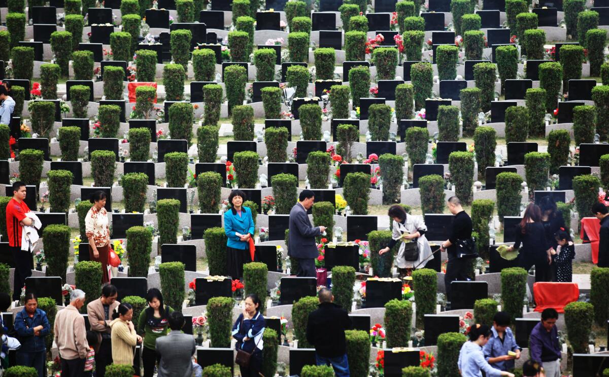 People gather to pay their respects at the gravestones of friends and relatives at Sanshan cemetery in Fuzhou, China, in 2011. Burial sites are becoming harder to find in China -- and a more lucrative business.