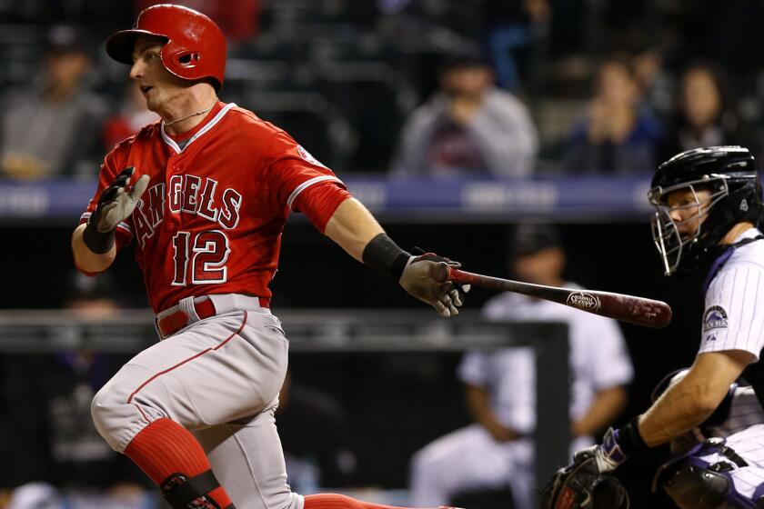 Angels second baseman Johnny Giavotella hits a run-scoring single against the Rockies in the ninth inning Wednesday night.
