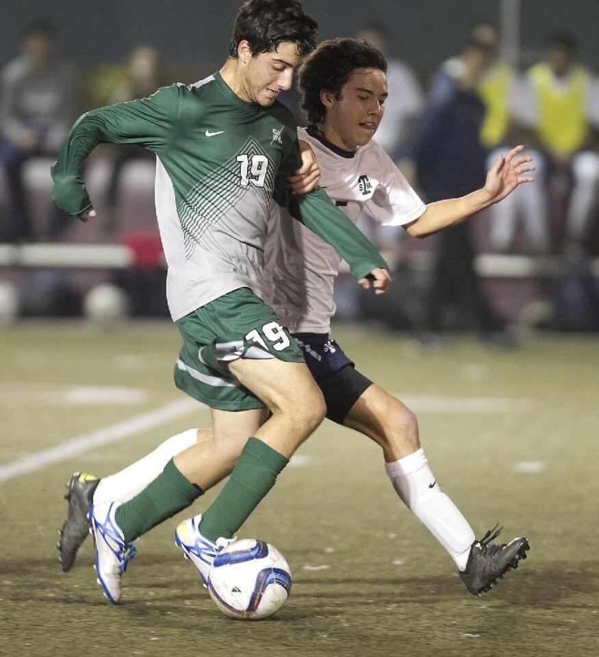 Sage Hill School's Adrian Boulos (19) battles a St. Margaret's defender for control of the ball.