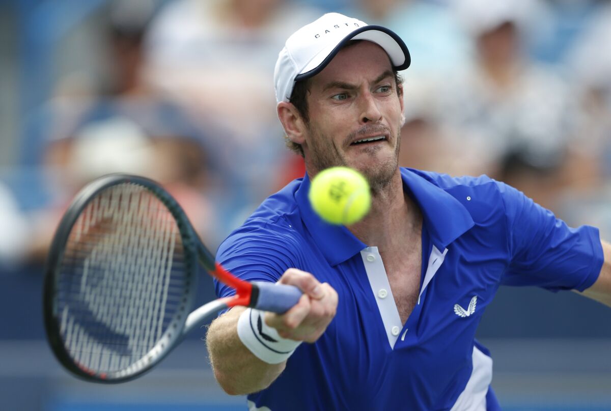 FILE - In this Monday, Aug. 12, 2019 file photo Andy Murray, of Britain, hits a forehand against Richard Gasquet, of France, during first-round play at the Western & Southern Open tennis tournament, in Mason, Ohio. Former world number one Murray's participation at the upcoming Australian Open is in doubt after the Briton tested positive for COVID-19. (AP Photo/Gary Landers, File)