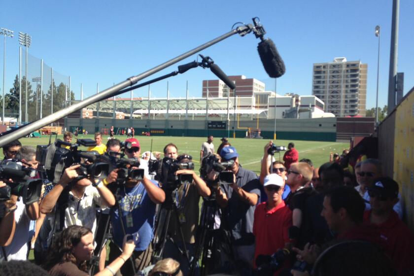 The media surround USC Coach Steve Sarkisian Aug. 27.