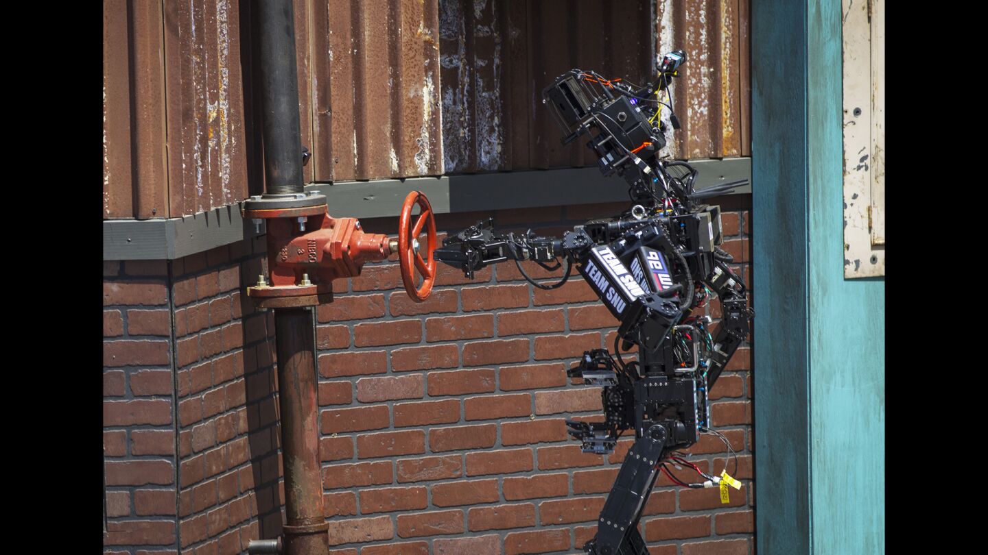 A robot built by a team from Seoul National University completes the 360-degree valve shutoff task during the DARPA Robotics Challenge.
