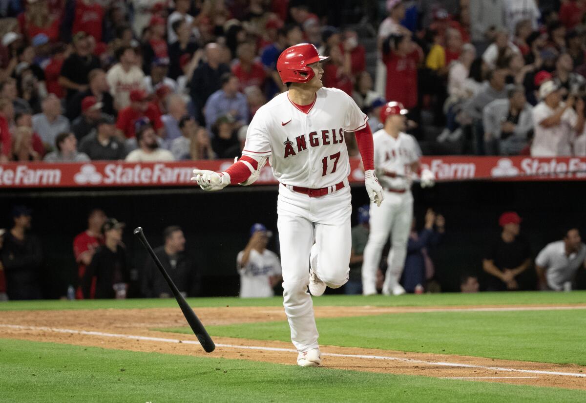 Angels designated hitter Shohei Ohtani (17) flips his bat after flying out against the Dodgers on June 20 in Anaheim.