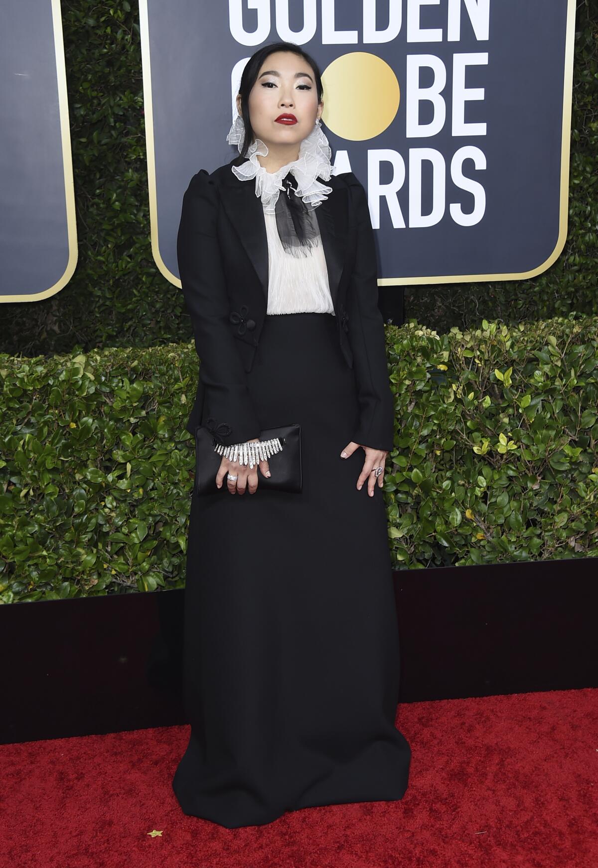 On the fence: Awkwafina in a black and white tuxedo-style look with a ruffled collar by Dior Haute Couture. 