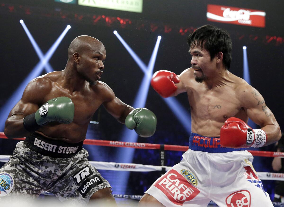 Timothy Bradley, left, trades blows with Manny Pacquiao during their WBO welterweight title fight on April 12, 2014. Pacquiao won a unanimous-decision victory.