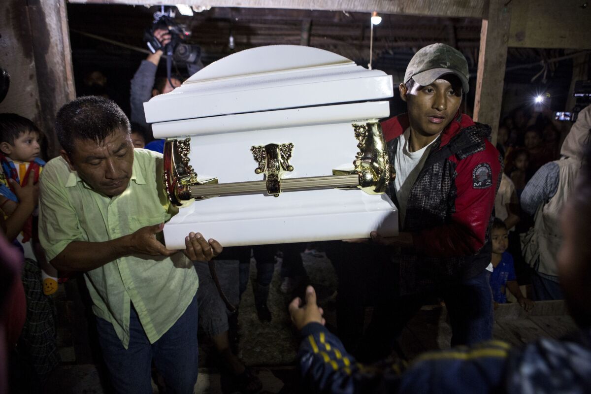 Neighbors carry the coffin of 7-year-old Jakelin Caal Maquin into her grandparents' home in San Antonio Secortez, Guatemala, in December.