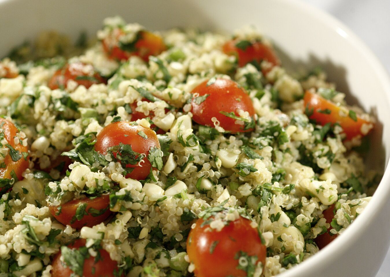 Quinoa salad with grilled corn, tomatoes and cilantro. Read the recipe