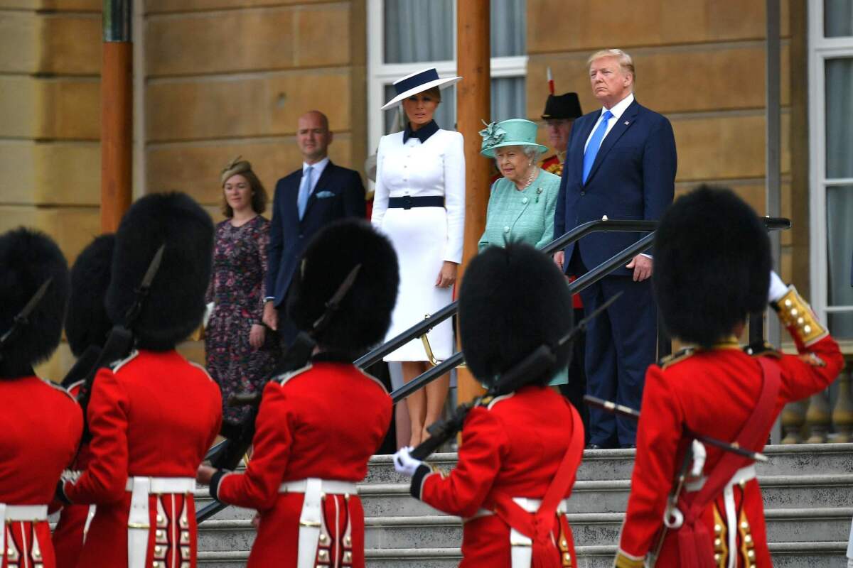 First Lady Melania Trump, Britain's Queen Elizabeth II and President Trump watch an honor guard during a welcome ceremony at Buckingham Palace on June 3, 2019.